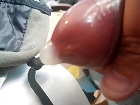 Jacking off my uncut cock, wearing a condom, cumming inside a condom. May 28, 2023.